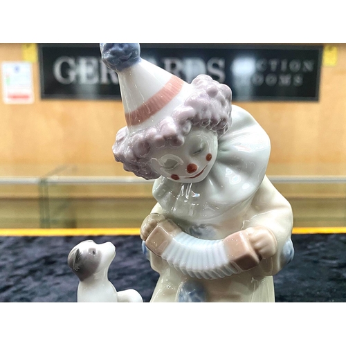 634 - Lladro Pierrot Clown with Puppy & Concertina.  No. 5279. Dated 1984, measures 6'' tall.