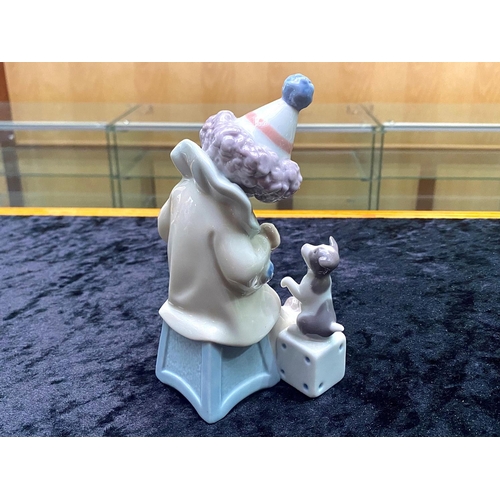 634 - Lladro Pierrot Clown with Puppy & Concertina.  No. 5279. Dated 1984, measures 6'' tall.