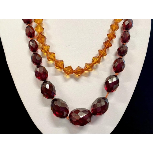 447 - Reconstituted Red Amber Faceted Necklace, c1925, beautiful, graduated beads, fastening with a grub s... 