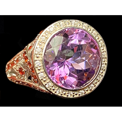 258 - Amethyst and Garnet Stylish Ring, a 6ct round cut amethyst, with a halo of small white topaz, set ab... 