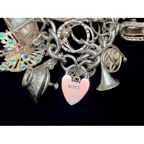 257 - Chunky Silver Charm Bracelet, Loaded with Different Charms, Which Includes Telephone, lamp, shoe, Ho... 