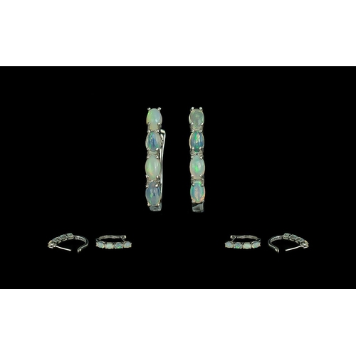 290 - Opal J-Hoop Earrings, four oval cut opals, displaying a variety of colours, set down the front of ea... 