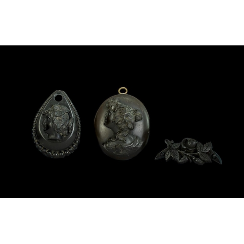 326 - Antique Jet Cameo Locket profile of a lady 45 by 40 mm. Together with a further jet pendant and a ca... 