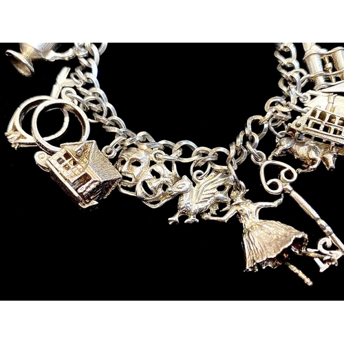 388 - Silver Charm Bracelet Loaded with Different Charms, Includes a Key, Jug, Horse, Sailing Boat, Duck, ... 