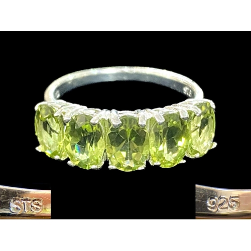 310 - Peridot Half Eternity Ring, five oval cut, bright, sparkling peridots, totalling 4cts, closely set i... 