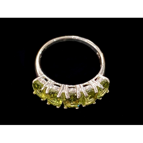 310 - Peridot Half Eternity Ring, five oval cut, bright, sparkling peridots, totalling 4cts, closely set i... 