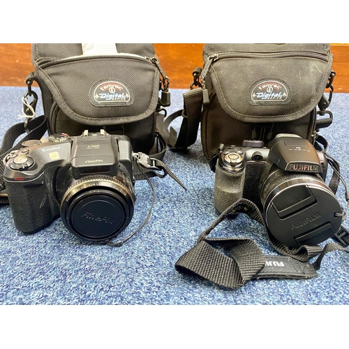 1597 - Two Cameras In Carry Cases, comprising  a Fine Pix S7000 camera, and a Fine Pix Fujifilm S4500.