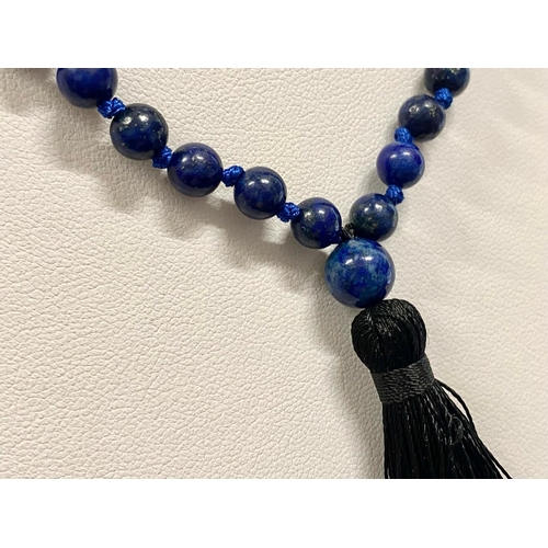 450 - A Lapis Lazuli Bead Necklace with black tassel trim.