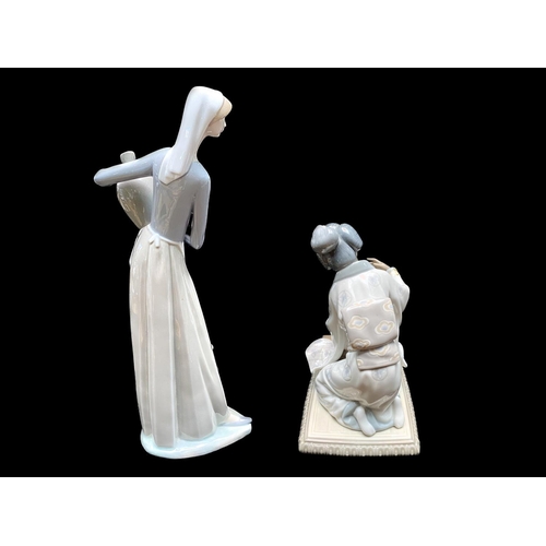 581 - Two Lladro Figures, depicting a water carrier, lady carrying water bottles, measures 13'' tall, toge... 