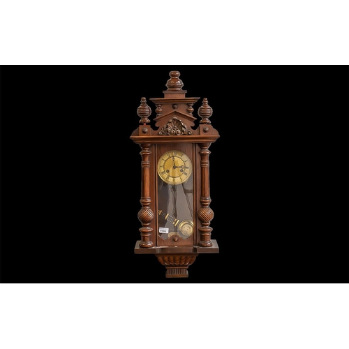 1135 - Vienna Wall Clock, working order, decorative columns, and carved finial.  Gold colour face with Roma... 