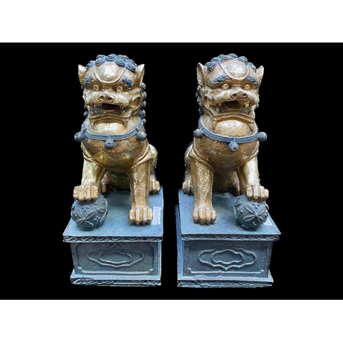 1094 - A Collection of Four Oriental Foo Dogs, two in resin on rectangular plinths, and two porcelain.  Tal... 