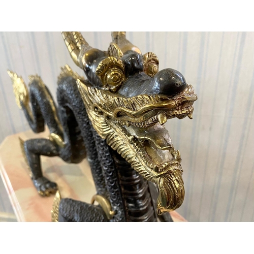 1095 - A Large Chinese Style Four Claw Bronze Dragon, brown textured body with gilt highlights.  Height 60.... 