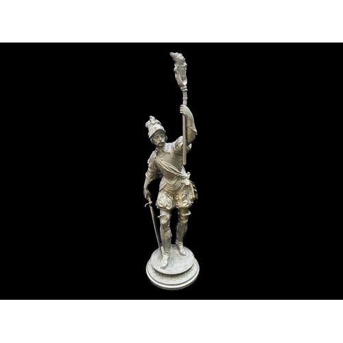 1244 - Metal Cast Figure of a Soldier, raised on a circular mount, holding a torch and sword.  Measures 16'... 