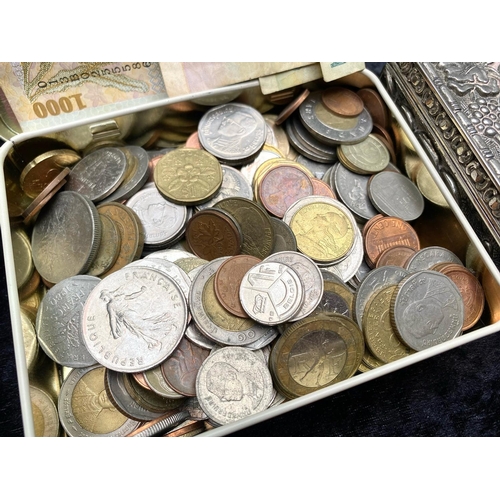 1374 - Tin of Assorted Foreign Coins, and banknotes, together with a white metal jewellery box with all ove... 