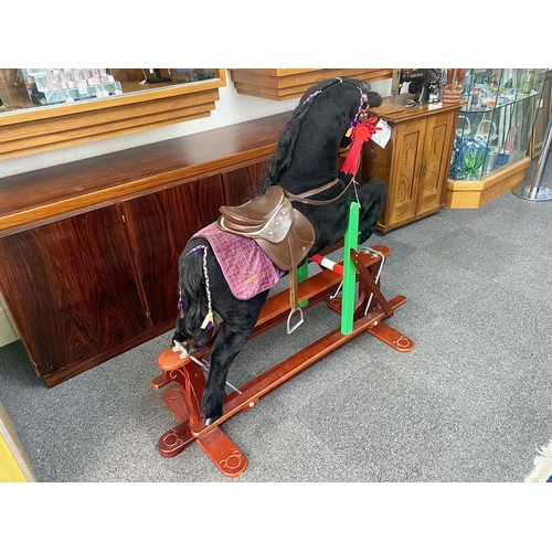 1585 - Beautiful Child's Rocking Horse, on wooden rockers, with brown leather saddle and bridle, with a pur... 