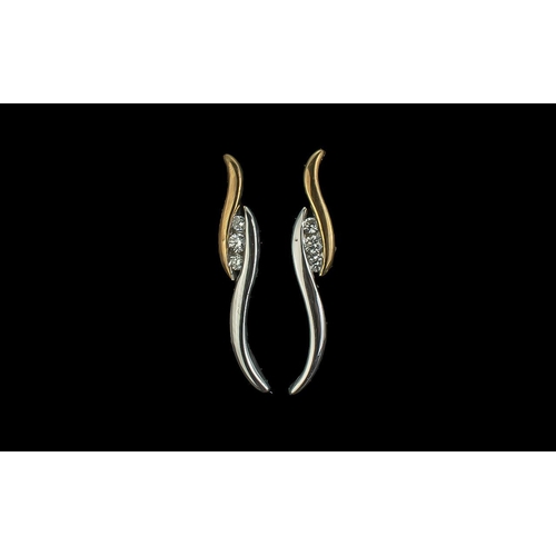 317 - 9ct Gold Two Tone Yellow & White Gold Earrings, each set with three round cut diamonds.  Weight 2.15... 