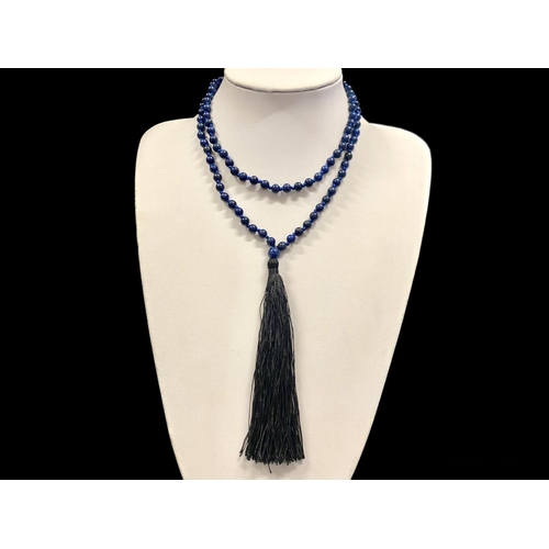 450 - A Lapis Lazuli Bead Necklace with black tassel trim.