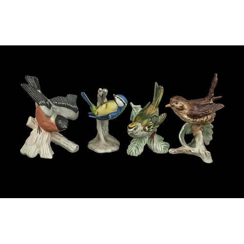 592 - Four Goebel Bird Figures, comprising Blue Titmouse 4'' tall,  Firecrest 4'' tall, a small spotted bi... 