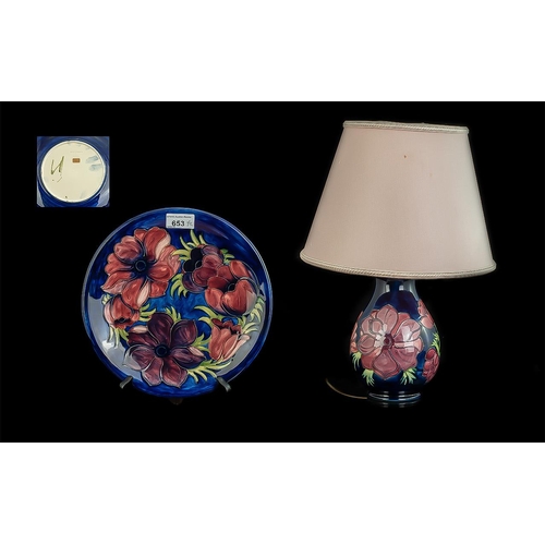 653 - Two Moorcroft Pieces, comprising a Table Lamp & Plate, Hibiscus pattern on a blue ground, plate 10''... 