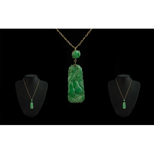 85 - Mid 20th Century 9ct Gold Mounted Jade Pendant attached to a 9ct gold chain, marked 9ct; the jade of... 