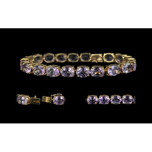 88 - 10ct Gold Attractive Amethyst Set Line Bracelet marked 10ct.  The well matched Amethysts of good col... 