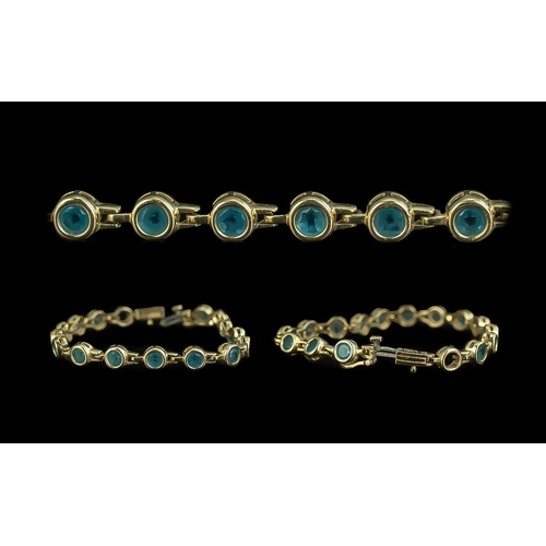 93 - Ladies 14ct Yellow Gold Line Bracelet, set with round blue Topaz well matched and good colour.  Mark... 