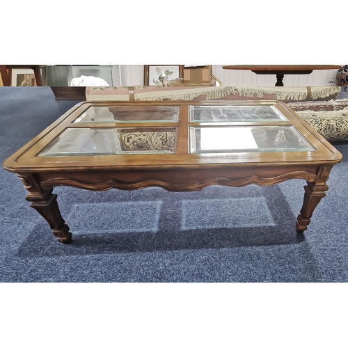 1062 - A Modern Walnut Coffee Table of Rectangular Form, four glass panels to the top, carved and shaped fr... 