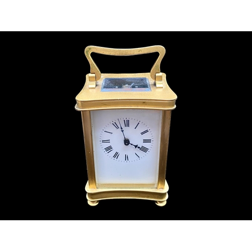 1103 - A Small Brass Carriage Clock of typical form, white enamel dial and Roman numerals. Height 4½ inches... 