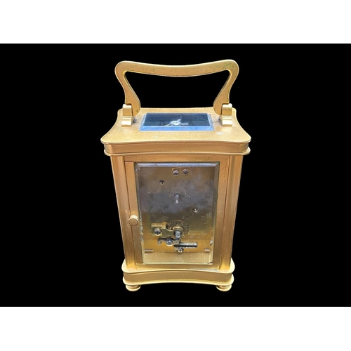 1103 - A Small Brass Carriage Clock of typical form, white enamel dial and Roman numerals. Height 4½ inches... 