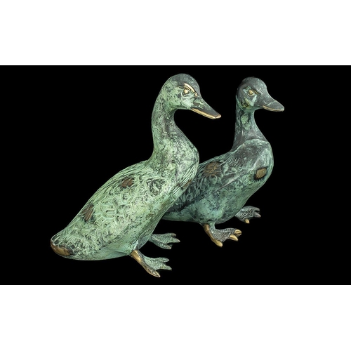 1238 - Pair of Bronze Ducks, 8'' tall, finished with a green patina.  Attractive items for home or garden.