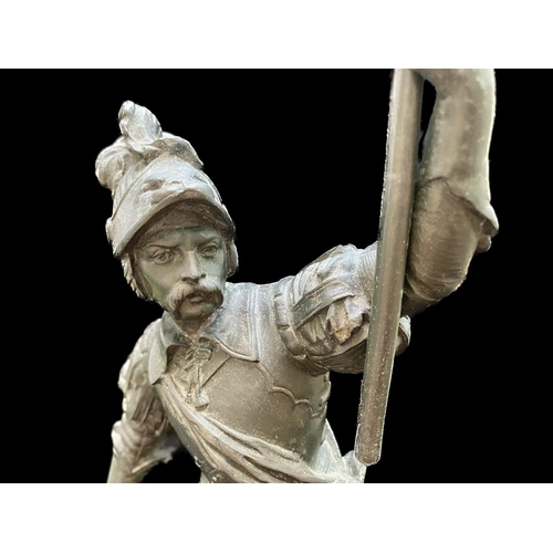 1244 - Metal Cast Figure of a Soldier, raised on a circular mount, holding a torch and sword.  Measures 16'... 