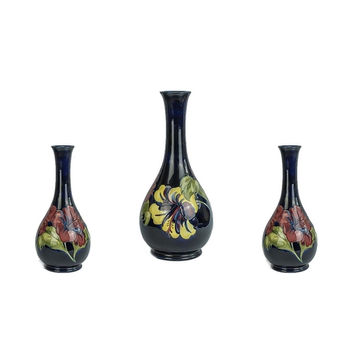 566 - Moorcroft Tall Tube lined Bulbous Vase with Long Stem. ' Hibiscus ' Variation Design on Blue Ground,... 