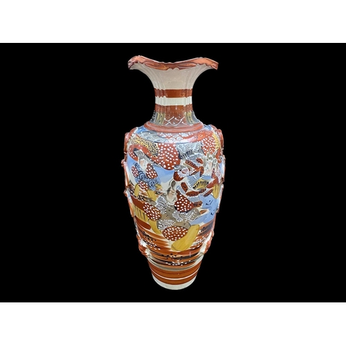 848 - Tall Oriental Vase, depicting Japanese figures with raised decoration and fluted top.  Marks to base... 