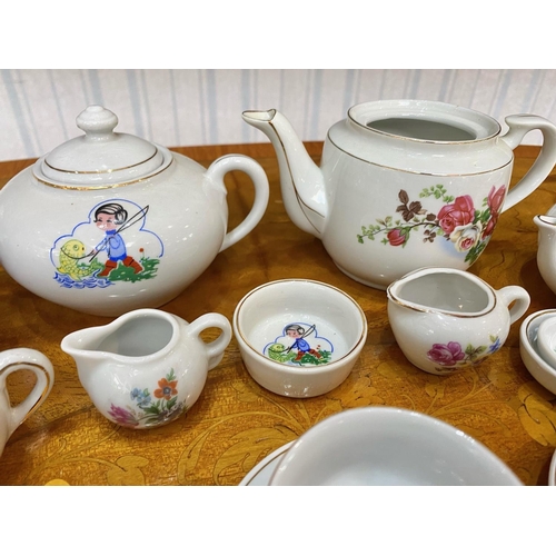 583 - Two Children's China Tea Sets, comprising tea pots, milk jugs, sugar bowls, cups and saucers, in whi... 