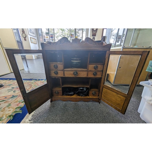 1022 - Wall Mounted Tobacco Cabinet in Oak, two bevelled glass doors with compartments and tobacco jars.  5... 