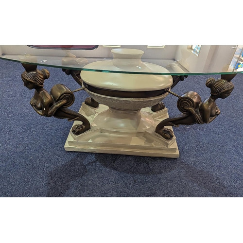 1050 - Glass Topped Coffee Table, oval shape, raised on a cream base with four classical bronzed figures ho... 