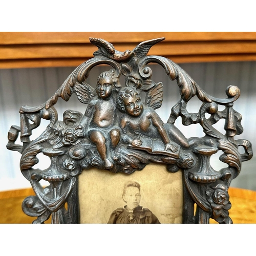 1236 - A Pair of Late Victorian Cast Metal Copper Patinated Easel Back Photo Frames with Cherub Finials, me... 