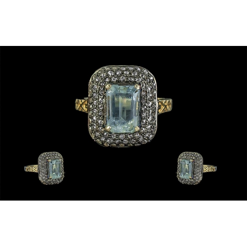 292 - Vintage Style Aquamarine and Diamond Ring with hand-carved design, in silver gilt. Emerald cut aquam... 