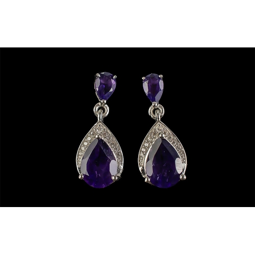 311 - Amethyst Pear Cut Drop Earrings, each earring having a large pear cut of the rich, deep purple ameth... 