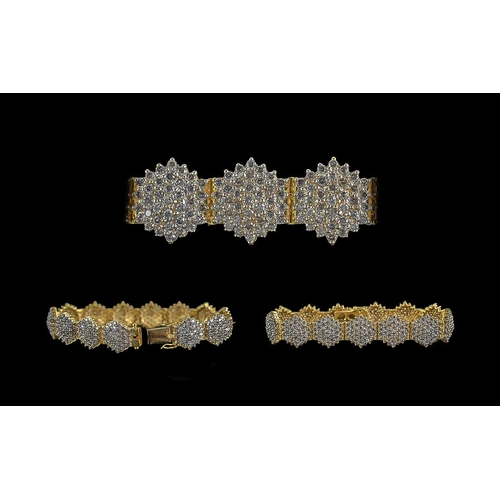 62A - Ladies Modern 18ct Yellow Gold Diamond Cluster Set Bracelet, consisting of thirteen diamond clusters... 