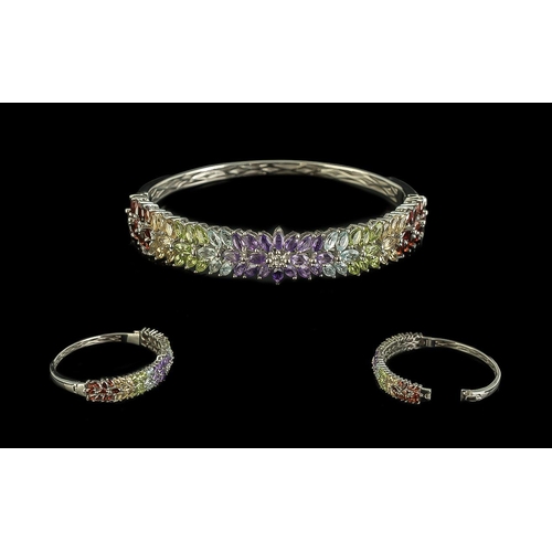 493 - Amethyst, Blue Topaz, Peridot, Citrine and Red Garnet Bangle, 12cts of the beautiful, clear and brig... 