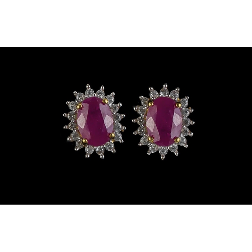 495 - Ruby Halo Stud Earrings, each of the two oval cut, rich red, rubies of 1.5cts, framed with a halo of... 