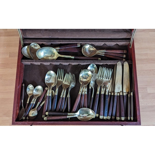 1040 - Boxed Canteen of Cutlery in gold tone with wood handles, housed in a wooden box.  Setting for six.