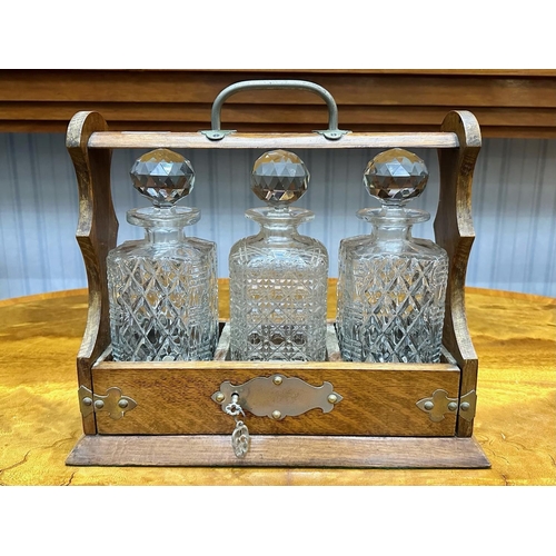 1071 - Tantalus 3 Cut Glass Bottle Set, In Wooden Holder with Key. Complete with Stoppers.