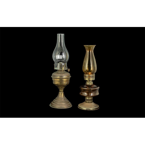 1170 - Two Vintage Oil Lamps, comprising a 17'' lamp on a brass base, and a Victorian pressed amber glass o... 