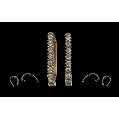 215 - Pair of 9ct yellow gold oval diamond bar-set hoop earrings. Round brilliant cut diamonds 1.00ct.