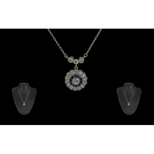 216 - Platinum Sapphire and Diamond Cluster Pendant and necklace with diamond-set bale, boxed. Calibre-cut... 