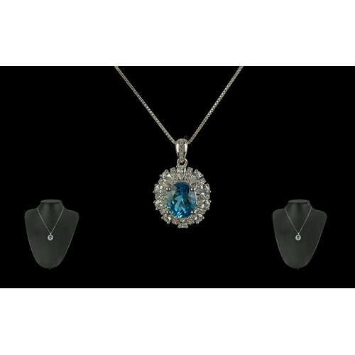 390 - Sterling Silver Pendant, set with a blue stone surrounded by crystals, suspended on a silver chain.