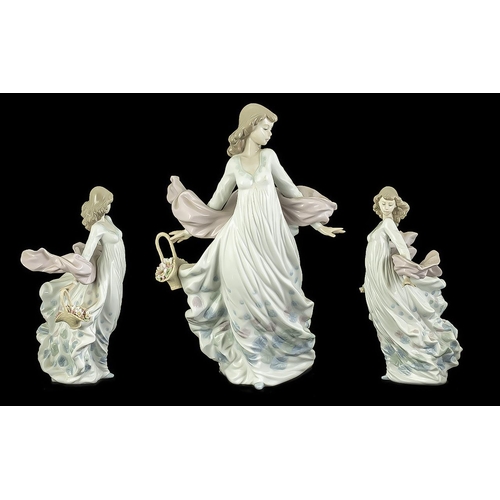 521 - Lladro 'Spring Splendour' Figurine No. 5898, depicts a lady with the wind blowing her shawl, carryin... 