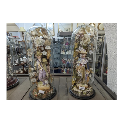 620 - Pair of Victorian Bisque Figures inside glass domes, a traditional lady and gentleman surrounded by ... 